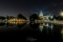 Beautiful photo of the United States Capital capturing the spotlight beams lighting the Capital Dome.